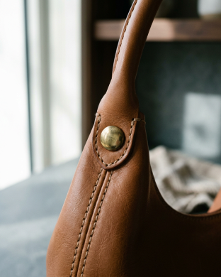 Metal rivet fastening a brown leather handle