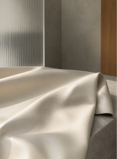 Smooth ivory material draped over a stone surface