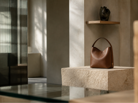 Brown Pakito bag displayed on a stone plinth