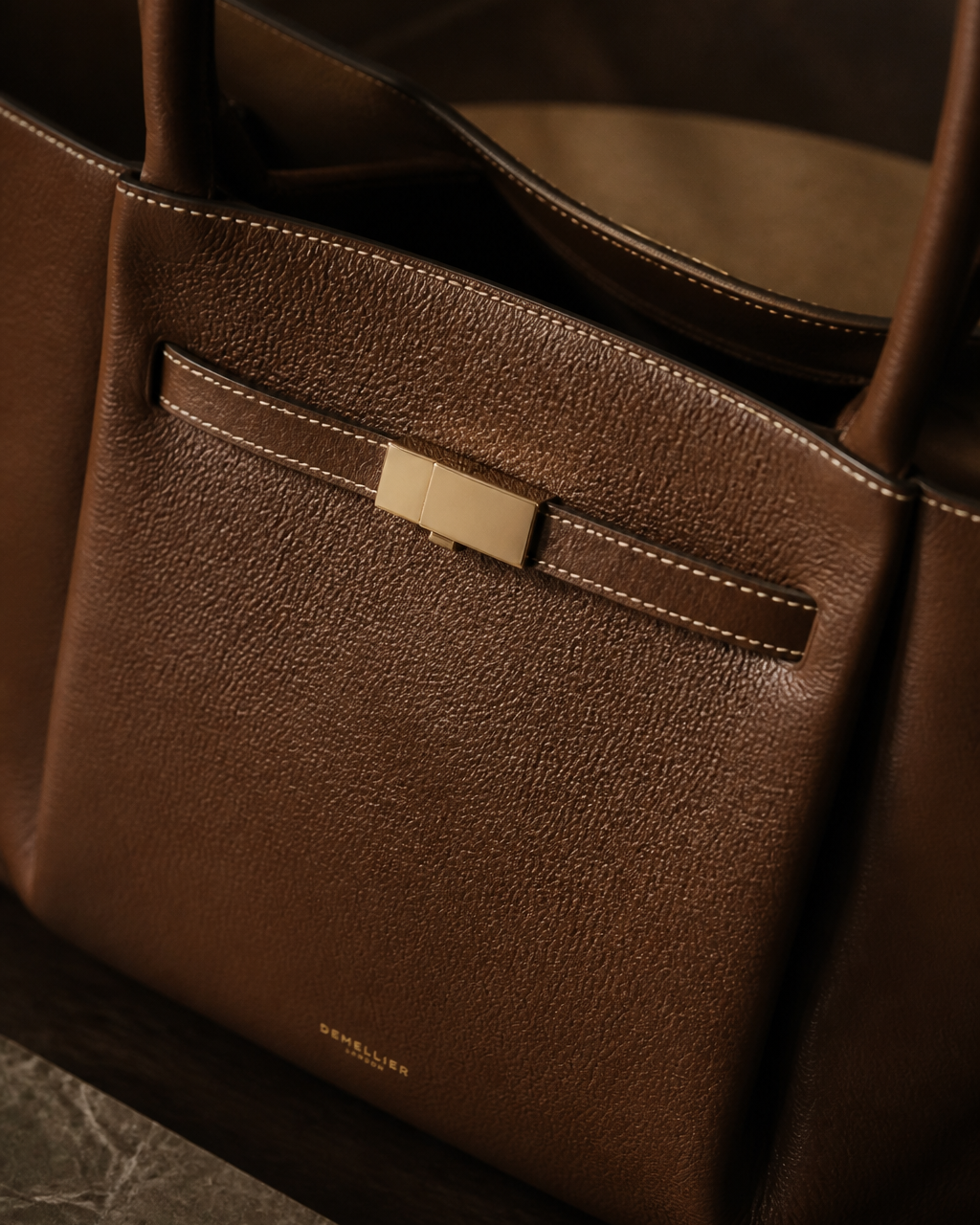 Close view of the tote bag's central metallic detail