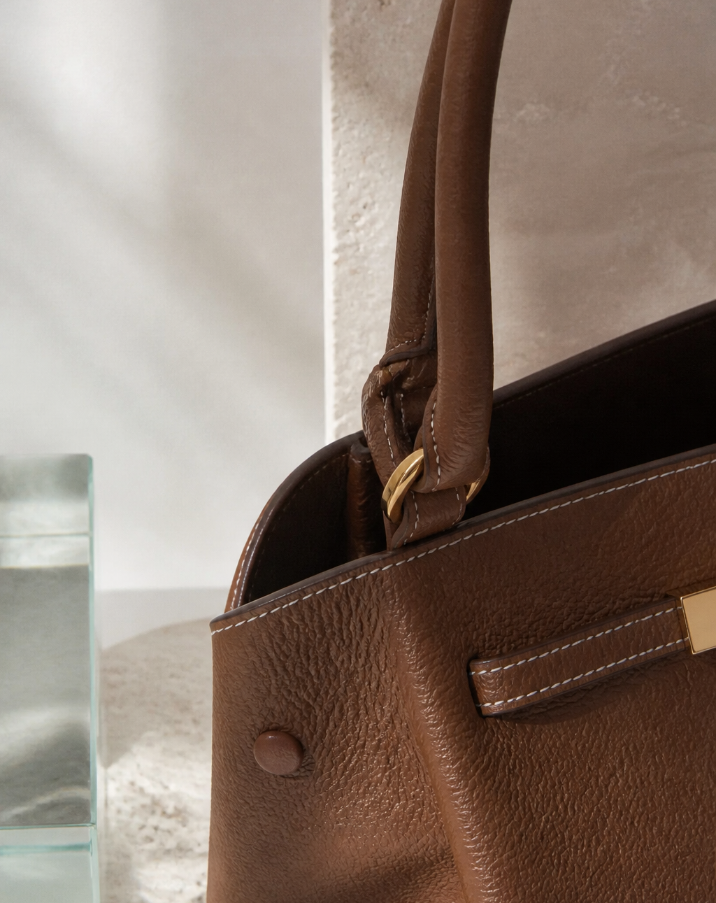 Tote bag worn to show the integrated hardware